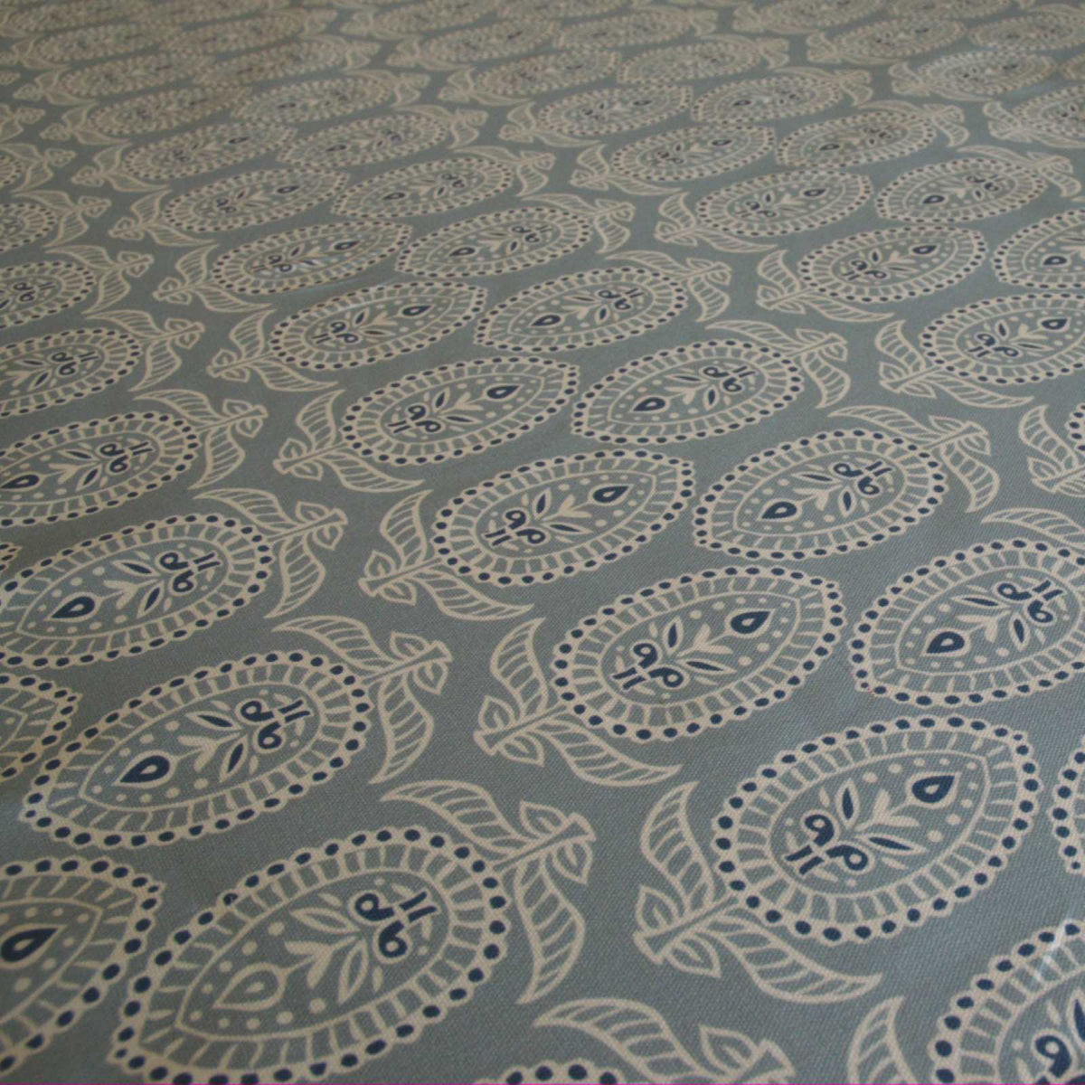 Curtain fabric with block print design on duck egg blue background