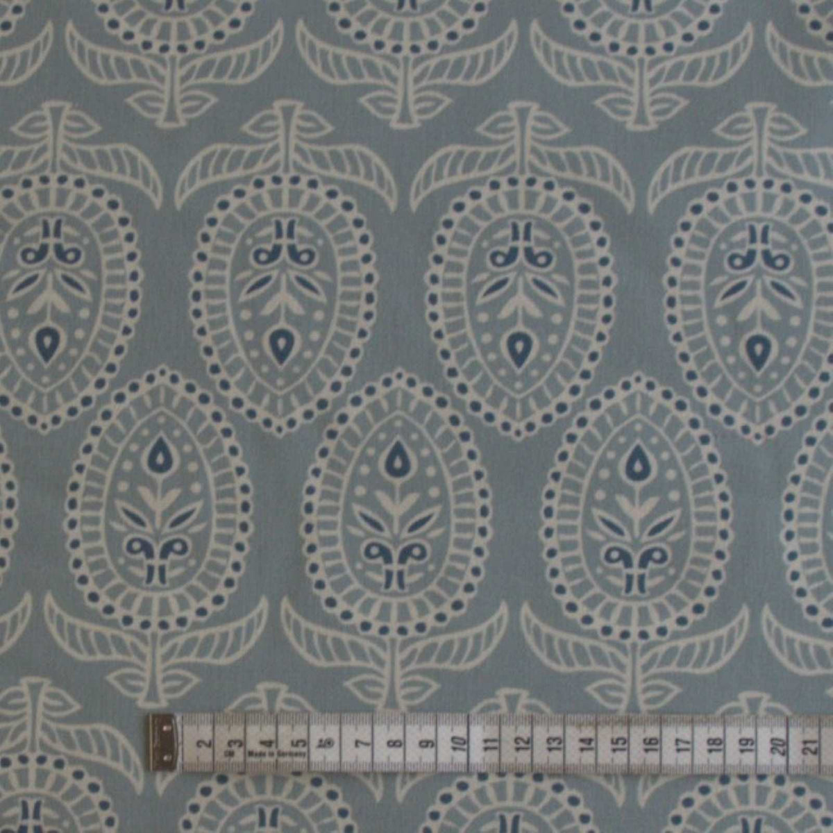 Curtain fabric in duck egg with rule to show size of block print design