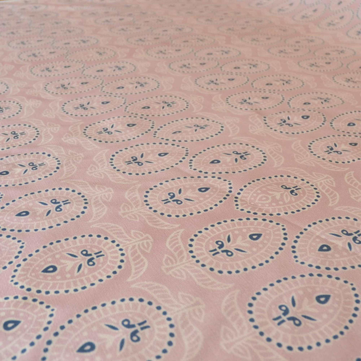 Curtain fabric with block print design on pale pink background