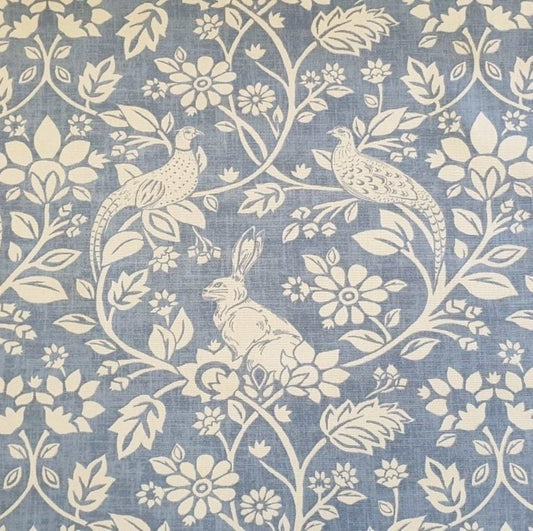 Hares and Pheasants design printed curtain fabric with a blue background and cream design