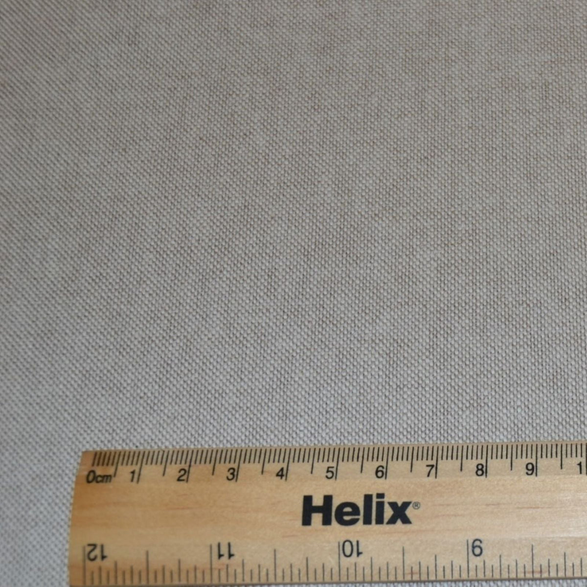 A plain linen look fabric with a rule for scale