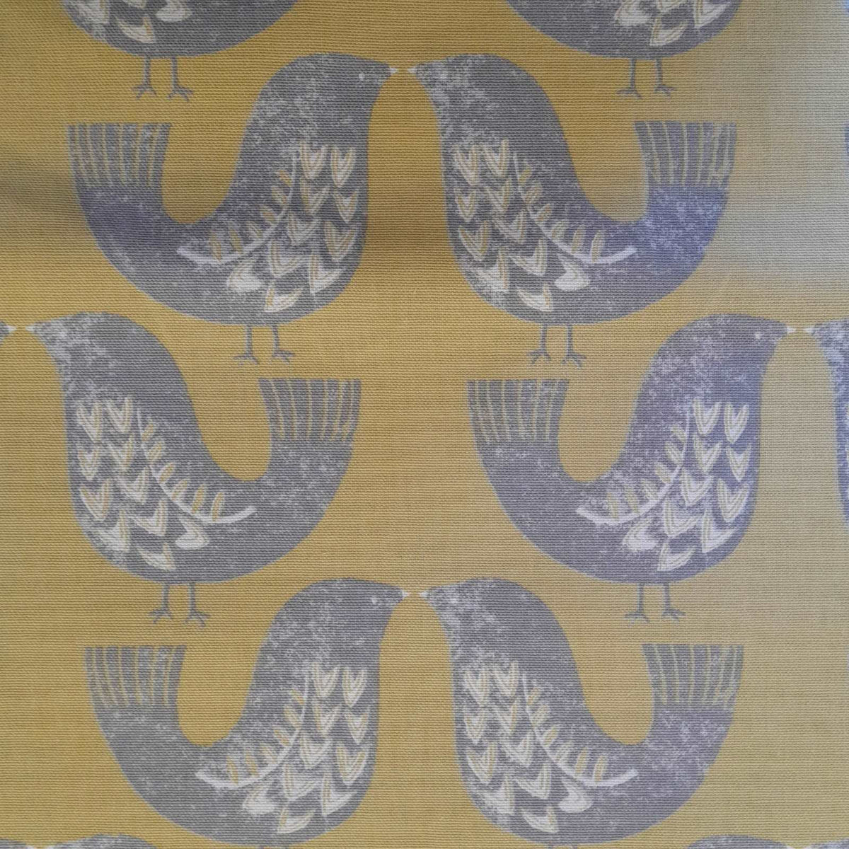 Curtain fabric with a scandi bird design in mustard