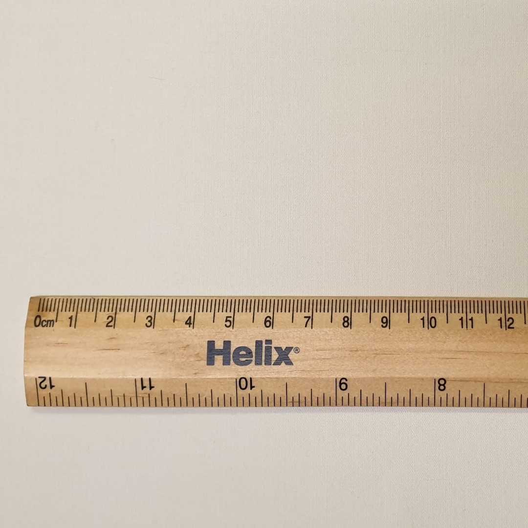 Close weave coated blackout lining fabric with a ruler 