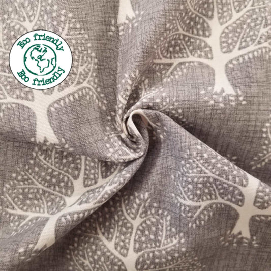 Sustainable Cotton Fabric with a print of trees on a grey background