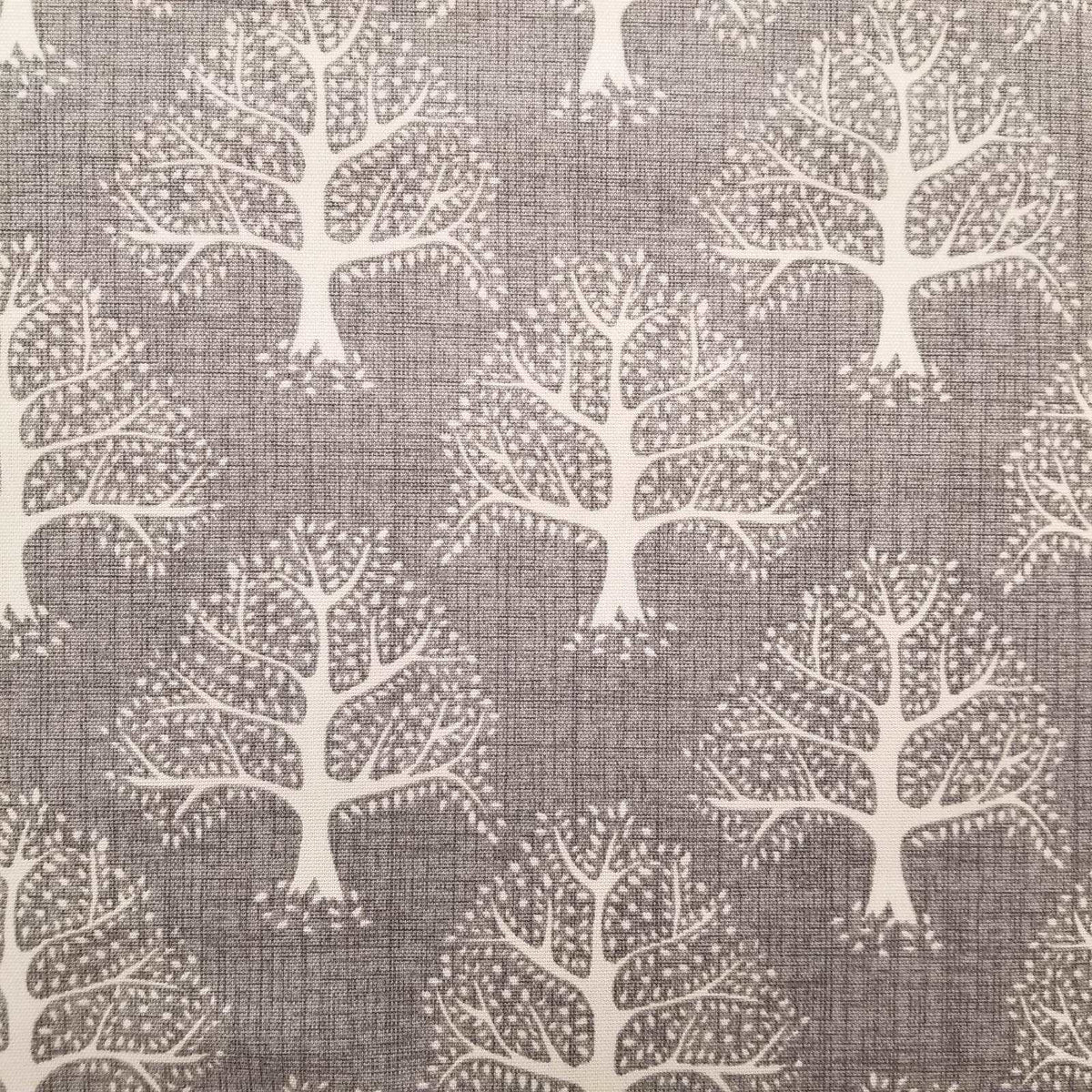 Sustainable Cotton Fabric with a print of trees on a grey background