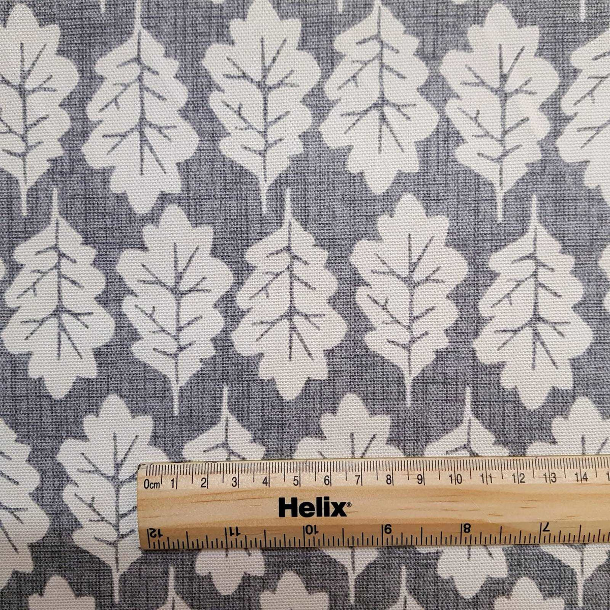Leaf print fabric in pewter with rule for scale