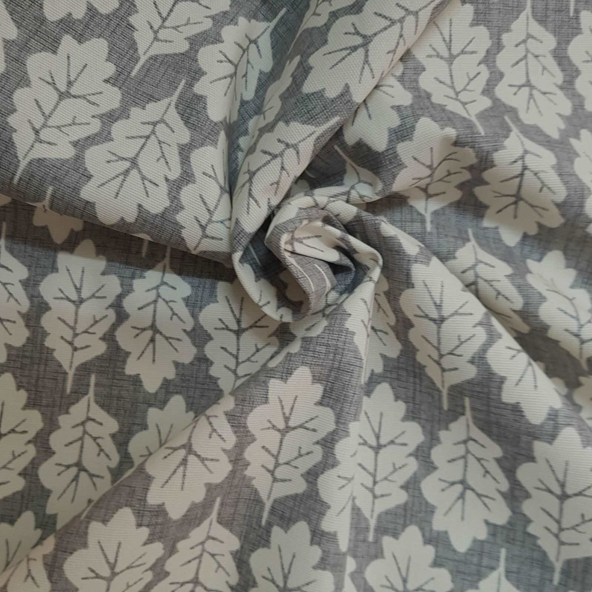 Grey curtain fabric with a leaf print